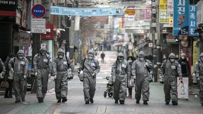 South Korean soldiers, in protective gear, disinfect the Eunpyeong district against the coronavirus in Seoul, South Korea. Getty Images