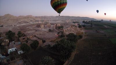 Tourist hot air balloons float across Egypt's Valley of the Kings near Luxor at dawn. Charles Onians / AFP