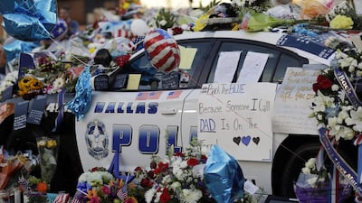 A Dallas police squad car becomes a makeshift memorial on July 9, 2016, to the five police officers shot dead. Eric Gay/ AP