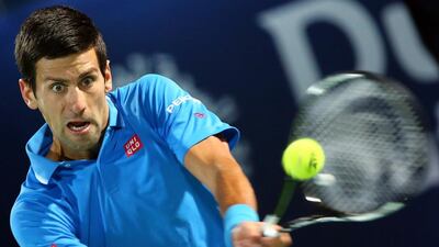 Djokovic returns the ball to Federer of Switzerland during the Dubai Duty Free Tennis Championships final. Marwan Naamani / AFP