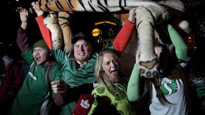 Saskatchewan Roughriders fans hoist a stuffed tiger in celebration of their victory. Frank Gunn / AP Photo / The Canadian Press