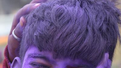 An Indian schoolboy doused in purple powder while celebrating the Holi festival in Nagrota Bagwan, near Dharamsala, India 28 February 2018. EPA