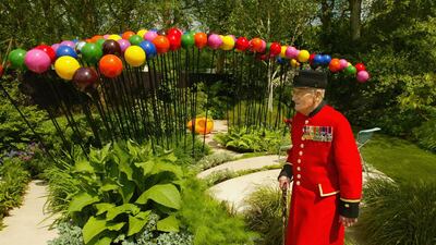 LONDON ? MAY 24: Chelsea pensioner Stan Kendrick examines the 'A Colourful Suburban Eden' garden, designed by Diarmuid Gavin, at the annual Chelsea Flower Show on May 24, 2004 in London, England. The show is due to open to the public on May 26 dates back to 1862. (Photo by Scott Barbour/Getty Images)