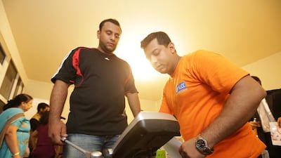 An entrant checks his weight at registration for Your Child in Gold, this year’s version of the Your Weight in Gold competition. Jaime Puebla / The National