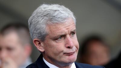 Queens Park Rangers manager Mark Hughes looks unimpressed as he watches his side lose to former club Manchester City. Jon Super/AP