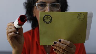 An electoral official holds an envelop at a polling station in Istanbul, on Sunday, June 23, 2019. AP Photo