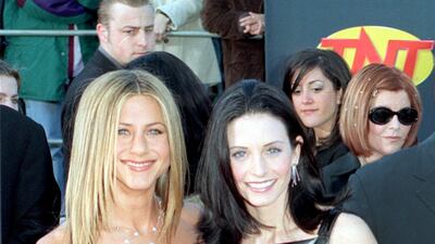 Jennifer Aniston, in a handkerchief top and maxi skirt, and Courteney Cox attend the annual Screen Actors Guild Awards at the Shrine Auditorium, in Los Angeles, California, on March 7, 1999. Getty Images