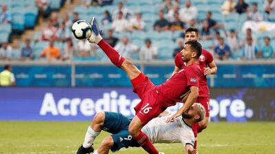 Argentina's Sergio Aguero vies for the ball with Qatar's Boualem Khoukhi. EPA