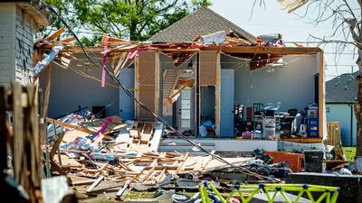 Debris litters the ground next to a severely damaged home following Tuesday night's tornado, in Arabi, Louisiana. The Daily Advertiser / AP