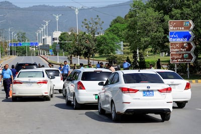 Police officers conduct security checks on vehicles passing by a road leading to the Serena Hotel in Islamabad. Reuters