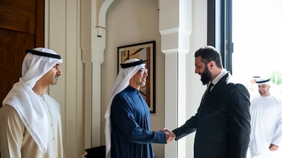 Sheikh Mansour bin Zayed, Vice President, Deputy Prime Minister and Chairman of the Presidential Court, centre, and Sheikh Hamdan bin Mohamed, left, greet Mr Al Shara at Al Shati Palace. Abdulla Al Bedwawi / UAE Presidential Court