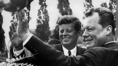 US president John Fitzgerald Kennedy (left) and West Berlin mayor Willy Brandt wave to crowds during the president's visit to Germany in 1963.