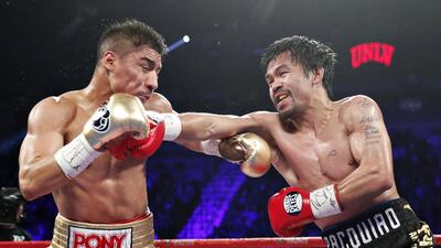 Manny Pacquiao, right, of the Philippines, hits Jessie Vargas. Isaac Brekken / AP Photo
