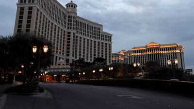 Most of the exterior building lights at Bellagio Resort & Casino, shown to the left of Caesars Palace, are turned off as parts of the Las Vegas Strip go dark as a result of the statewide shutdown due to the coronavirus. Getty Images