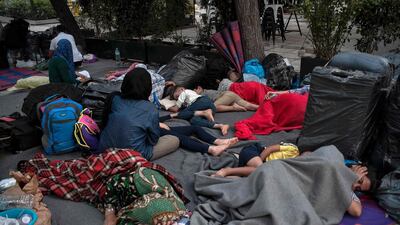 Refugee families sleep at Victoria square in central Athens, Greece. AFP