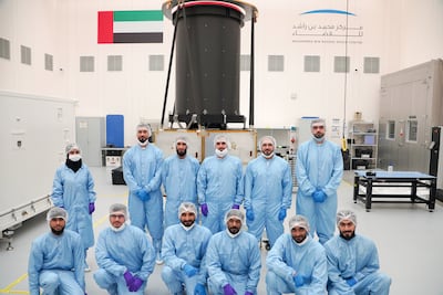 Emirati engineers posing in front of the MBZ-Sat satellite at a clean room in the Mohammed bin Rashid Space Centre. Photo: The Government of Dubai Media Office