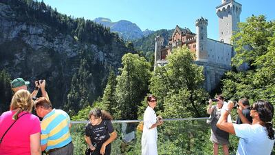 Gulf tourists to Germany are among the highest spenders, spending €600 a day. Above, tourists on a viewing platform in front of Neuschwanstein Castle near Hohenschwangau, Germany. Karl-Josef Hildenbrand / EPA