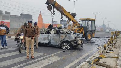 Policemen investigate the scene of a car accident near Roorkee, where Rishabh Pant was driving the car that overturned and caught fire after hitting a road divider. AP
