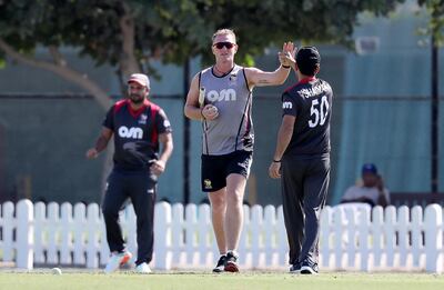 Dougie Brown, giving his UAE players a high-five before the game, was disappointed by the end of it. Pawan Singh / The National