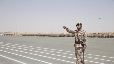 Sheikh Hazza bin Zayed Al Nahyan, Vice Chairman of the Abu Dhabi Executive Council, Sheikh Hamdan bin Mohammed, Crown Prince of Dubai, and Lt Gen Hamad Al Romaithi, Chief of Staff UAE Armed Forces, inspect National Service military personnel during a ceremony marking the 40th anniversary of the Armed Forces unification, and the graduation ceremony for the 5th batch of National Service personnel, at the Seeh Al Hama camp. Ryan Carter / Crown Prince Court - Abu Dhabi