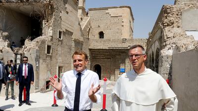 French President Emmanuel Macron gestures as he visits Al-Sa'ah church in the Old City of Mosul. Reuters