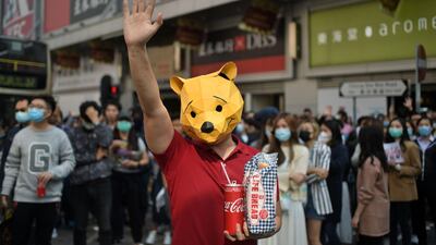 A man wears a Winnie the Pooh mask at a lunchtime flash mob rally in the Cheung Sha Wan district in Hong Kong on November 29, 2019. AFP