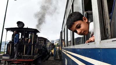 A boy looks out of a Darjeeling Himalayan Railway train in Darjeeling.