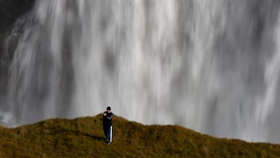 A tourist takes a selfie photograph in an area forbidden to walking, overlooking the waterfalls in Gullfoss, Iceland. Reuters