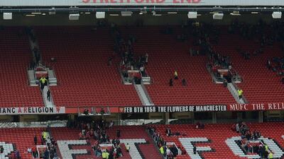 Fans leave the the Stretford End and the Sir Alex Ferguson Stand (unseen) following an evacuation of both stands on Sunday. Oli Scarff / AFP / May 15, 2016