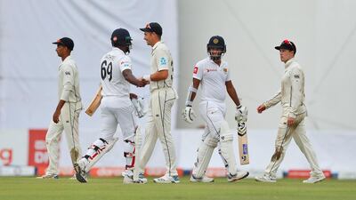 Sri Lanka batsmen Dimuth Karunaratne, second right, and Angelo Mathews, second left, leave the field after Day 1 of the Colombo Test. AP Photo