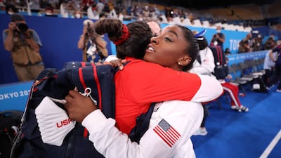 Simone Biles of Team United States embraces teammate Sunisa Lee.