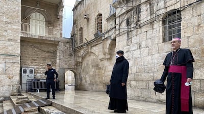 Archbishop Pierbattista Pizzaballa, apostolic administrator of the Latin Patriarchate of Jerusalem stands at the entrance to the Church of the Holy Sepulchre for the Good Friday service. Reuters
