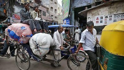 A busy New Delhi street. The rupee strengthened after the central bank governor announced plans to attract more foreign deposits. Saurabh Das / AP Photo