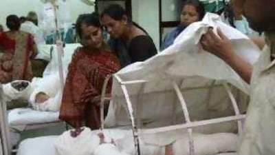 A woman visits her son at the Civil Hospital in Ahmedabad.