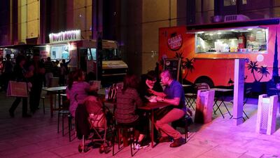People eat from food trucks during New Years Eve festivities at The Galleria in on Al Maryah Island in Abu Dhabi. Christopher Pike / The National