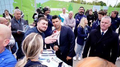 Sergio Aguero poses for picture with Manchester City supporters outside the Etihad Stadium. AP