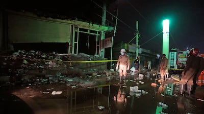A fire official walks out of the building. AP