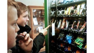 Daniel Kennedy, left, 14, and Tom Lofthouse, 13, in Dunstable, Britain, choose a snack, which researchers warn could lead to obesity.
