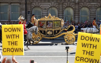 King Charles III and Queen Camilla are driven to Parliament in a state carriage as an anti-monarchy group protests along the route. Getty Images
