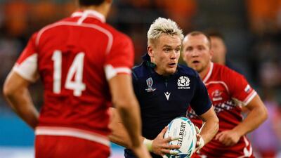 Scotland's wing Darcy Graham (C) runs with the ball on his way to making a pass to Scotland's scrum-half George Horne for a try during the Japan 2019 Rugby World Cup Pool A match between Scotland and Russia at the Shizuoka Stadium Ecopa in Shizuoka. AFP