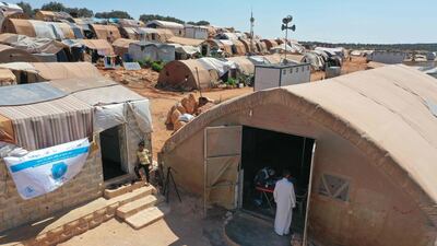 People enter a tent turned into a vaccination centre as medics from the "Syria Immunization Group" NGO administer the COVID-19 AstraZeneca vaccine to patients with chronic diseases, at a camp for the internally displaced near Marret Misrin town, in the north of Syria's rebel-held Idlib governorate. AFP