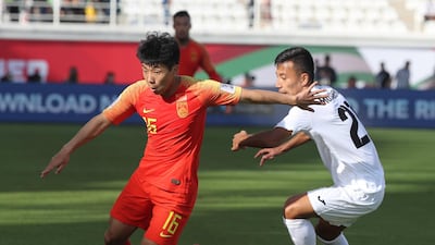 Kyrgyzstan's midfielder Farhat Musabekov tussles for the ball with China's midfielder Jingdao Jin. AFP