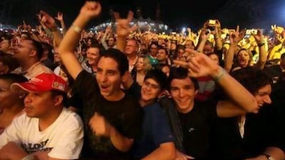 Fans cheer during a Guns and Roses concert at Yas Marina. Misting machines and a cooling dome will be set up for Madonna's concerts.