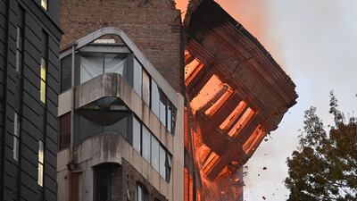 The entire top floor wall crashes into pieces into the street below. EPA