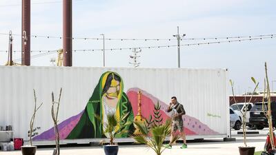Marsa Mina's shipping container retail outlets have been decorated with street art. Khushnum Bhandari for The National