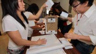 Philippine citizens count vote for the first automated national elections at the Philippine embassy in Abu Dhabi.