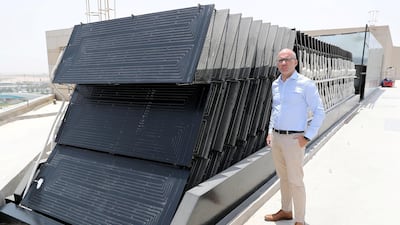 Hugo Domingues, business director at Energie GCC, shows off the compact solar installation, capable of heating 45,000 litres of water a day, on the roof of the Radisson Blu on Yas Island in Abu Dhabi. Pawan Singh / The National