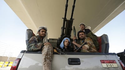 Houthi fighters ride a military truck outside the Presidential Palace in Sanaa on January 21, 2015. Khaled Abdullah / Reuters