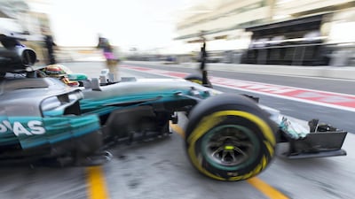 Mercedes-GP's Lewis Hamilton, tied with Sebastian Vettel on three Abu Dhabi Grand Prix wins, drives out on to the Yas Marina Circuit track. Christopher Pike / The National