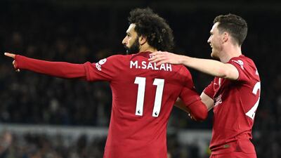 Liverpool striker Mohamed Salah celebrates with Andrew Robertson after scoring their second goal. AFP